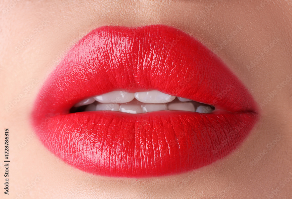 Obraz premium Woman with beautiful red lipstick on her lips, macro view