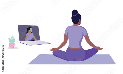Young woman practicing yoga at home following an online instructor on her laptop computer in a serene and healthy lifestyle setting