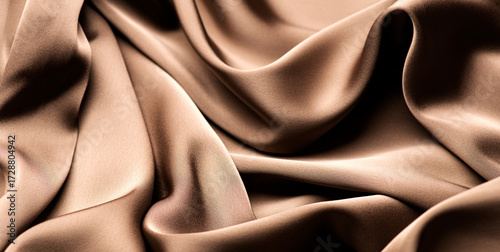 Satin, chocolate brown color silk background, texture of beautiful dark beige satin fabric close-up. Abstract smooth backdrop 