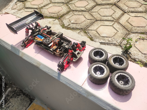 Remote control Buggy car without body cap. Buggy RC Car disassembled and tires removed for cleaning and drying. Automotive and electronic parts. Hobby toy maintenance
