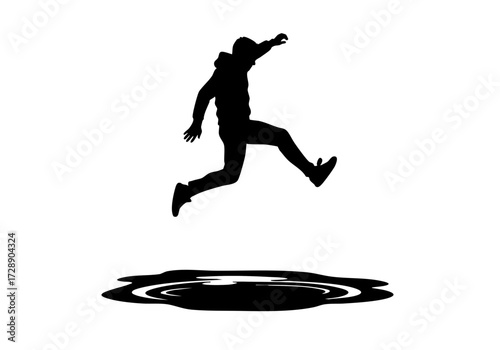 A silhouette of a person jumping across a puddle.