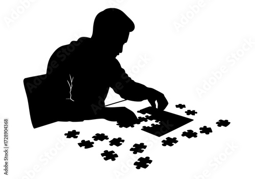 Silhouette of a person focused on completing a jigsaw puzzle