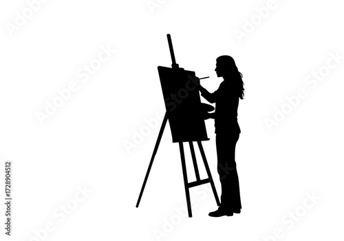 Silhouette of a person painting on an easel.