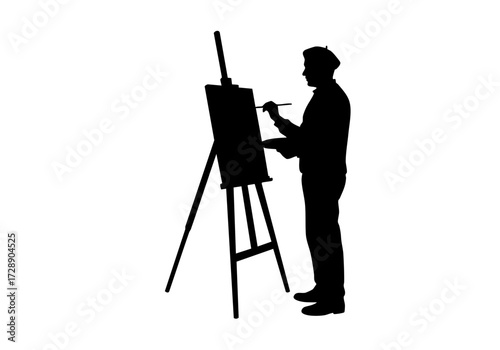 Silhouette of an artist focused on their painting.