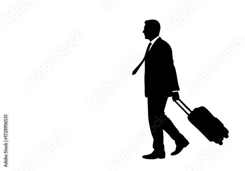 A businessman walking and pulling a suitcase.