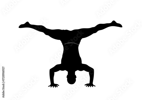Silhouette of a man doing a handstand.