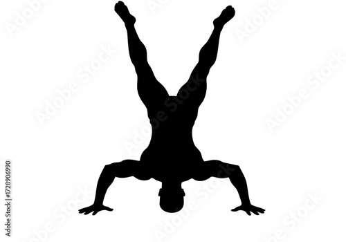 A determined silhouette person performing a handstand.