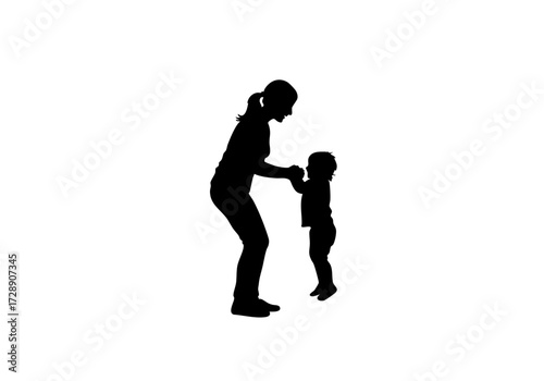 A silhouette image of a mother helping her child take their first steps.