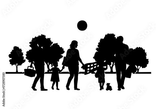 A family enjoying a day out in the park, captured in a silhouette. 