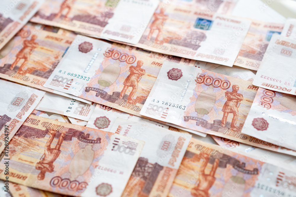 Obraz premium A collection of Russian ruble banknotes laid out on a flat surface highlights the significance of currency in everyday transactions and economic activities.