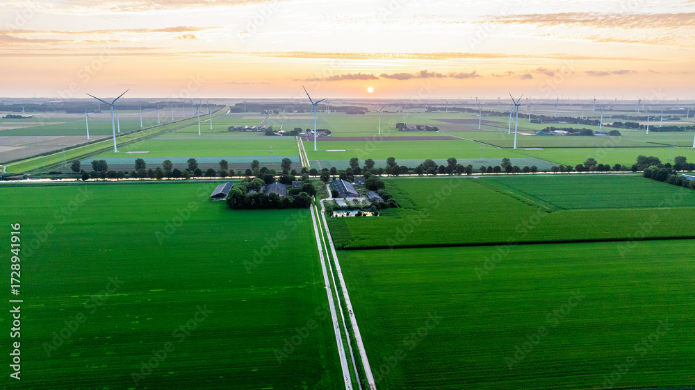 Obraz premium Drone view of wind farm with huge generator turbines. Sunset. Holland. Modern green technologies.