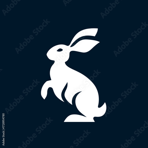White hare standing, silhouetted against a dark blue background