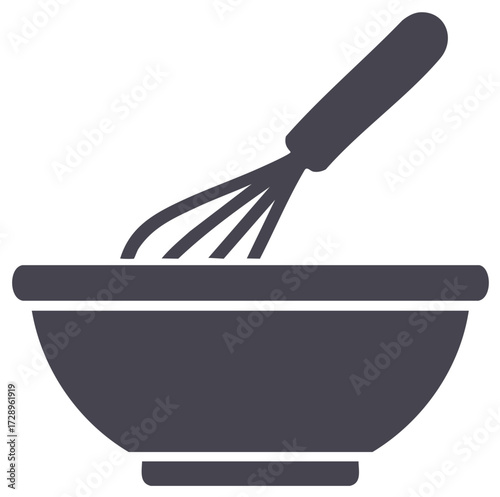 Kitchen whisk mixing ingredients in a bowl for baking or cooking preparation