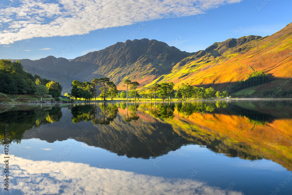 Fototapeta premium Beautiful autumn reflections at Buttermere on a sunny morning with calm reflections, Lake District, UK.
