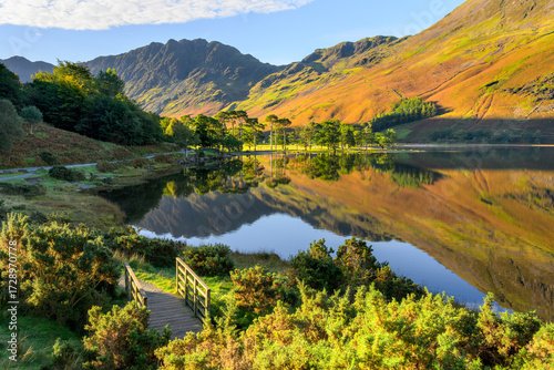 Beautiful autumn morning with reflections at Buttermere Lake in The Lake District, UK.