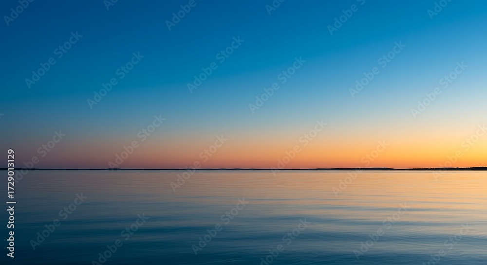 Fototapeta premium Tranquil waterscape serene horizon with gradated sky at sunset