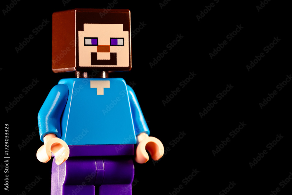 Naklejka premium LEGO Minecraft Steve stands on a black background