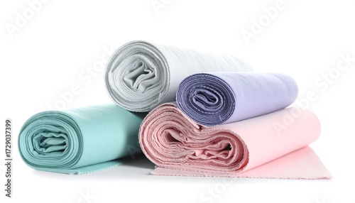 Rolls of pastel colored fabric neatly stacked.