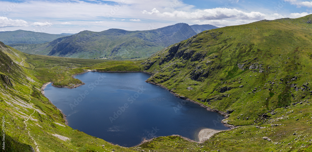 Fototapeta premium Ffynnon Llugwy reservoir below Carnedd Llewelyn, known as Carnedd Llywelyn, a mountain in the Carneddau range in Snowdonia National Park, officially known as Eryri National Park in northwest Wales, UK