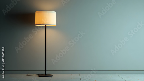Minimalist floor lamp casting warm light on a muted teal wall and tiled floor
