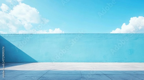 A blue wall with a shadow and a white floor.