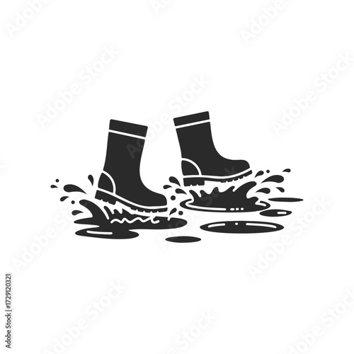 Pair of boots splashing in puddle