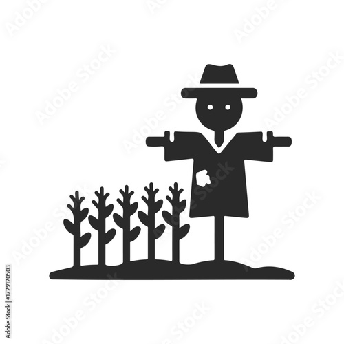 Silhouette of scarecrow in hat with crops in black and white