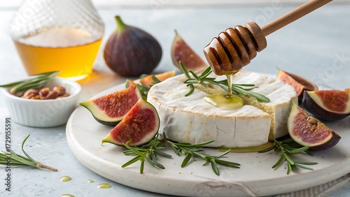 Delicious baked brie cheese with fresh figs rosemary and drizzled honey on a rustic plate