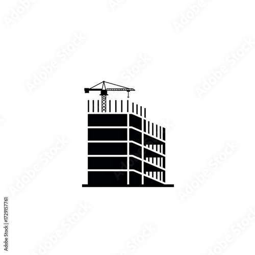 Building under construction with a crane on top.
