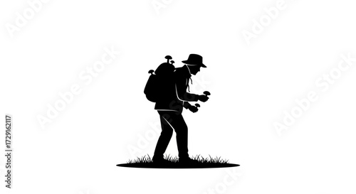 Silhouette of hiker with backpack foraging for mushrooms in a grassy field