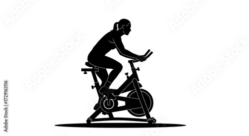 Focused woman silhouette cycling vigorously on stationary bike for intense cardio workout