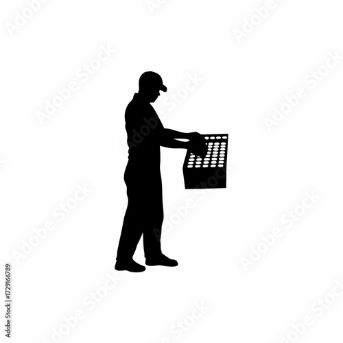 Silhouette of a worker tending to eggs in an incubator isolated on white background
