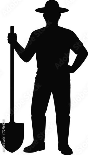 Farmer with shovel standing boots