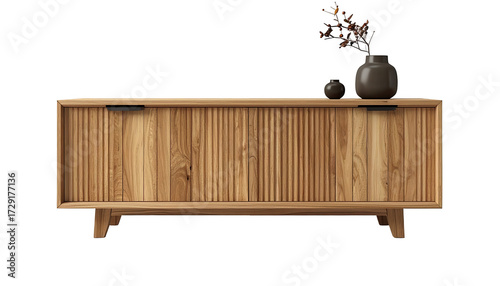 Stylish wooden sideboard featuring fluted door panels stands against a black background, complemented by a small vase and a larger decorative container holding a branch, presenting an elegant home...