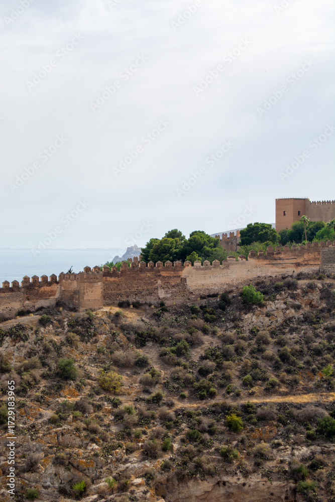 Fototapeta premium Historic castle wall overlooking coastal landscape