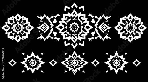 Intricate white geometric patterns arranged on a black background, showcasing symmetry and design.