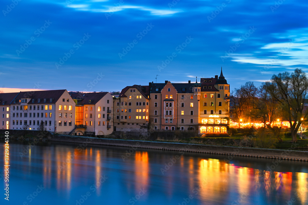 Fototapeta premium Beautiful old buildings and Danube river at night in Regensburg, Germany
