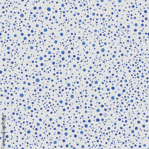 seamless polka dot pattern. tiny blue repeat dots design with random sized circles on cream background  for fabric prints, wallpaper and surface decoration