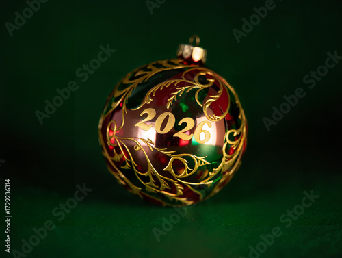Decorative New Year Ornament in Red and Gold Representing 2026 on a Green Background with Copy Space