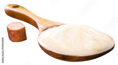 spoon of pork fat, lard used as a culinary ingredient in Brazil, pork meat in the background