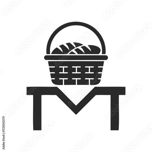 Basket of bread on table icon: simple black and white graphic design