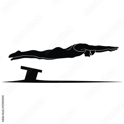 Silhouette of a Swimmer Diving from a Starting Block in a Swimming Competition