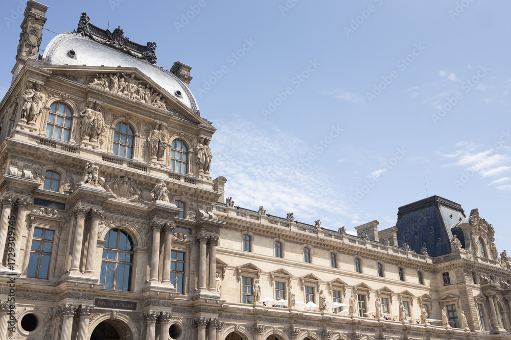 Fototapeta premium Historic architectural masterpiece showcasing intricate stonework and ornate details under a clear blue sky, representing cultural heritage and artistic achievement