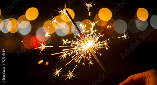 Sparkler emitting bright light against dark background.