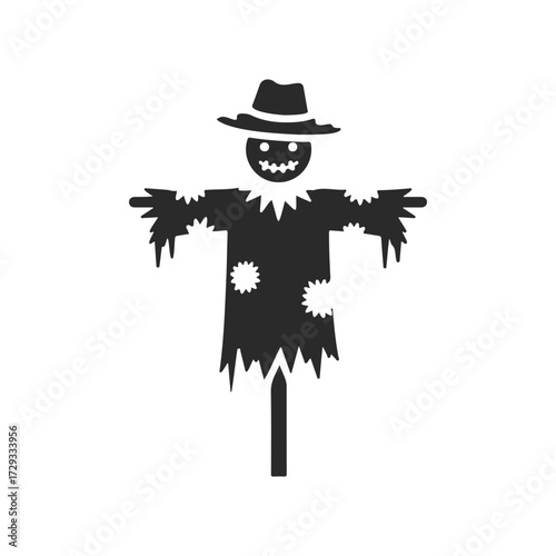 Black silhouette of a scarecrow with hat and patchwork clothing