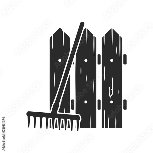 Silhouette of garden rake and wooden fence panels on white background