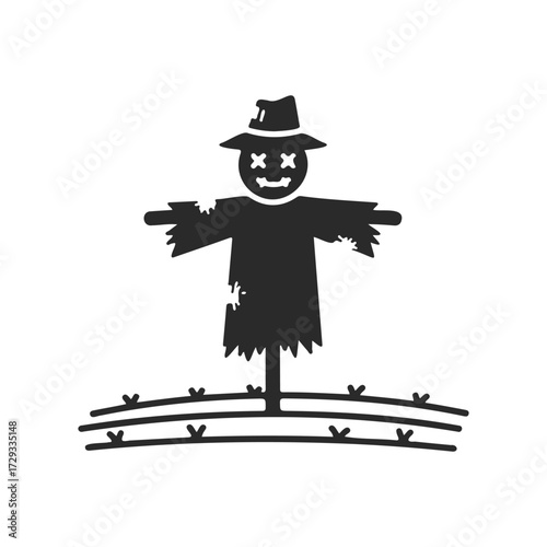 Classic scarecrow silhouette on farmland with hat and ragged clothes