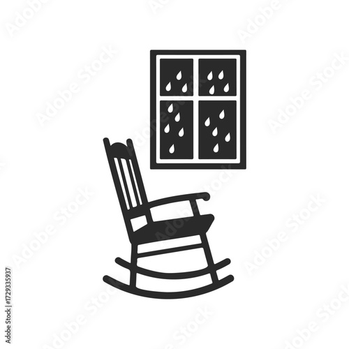 Silhouette of rocking chair by rainy window