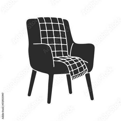 Modern armchair with geometric patterned throw blanket on white background
