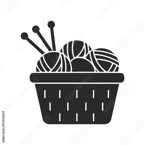 Basket of yarn and knitting needles icon in black and white